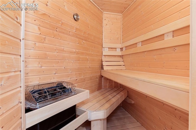 view of sauna / steam room featuring wooden walls