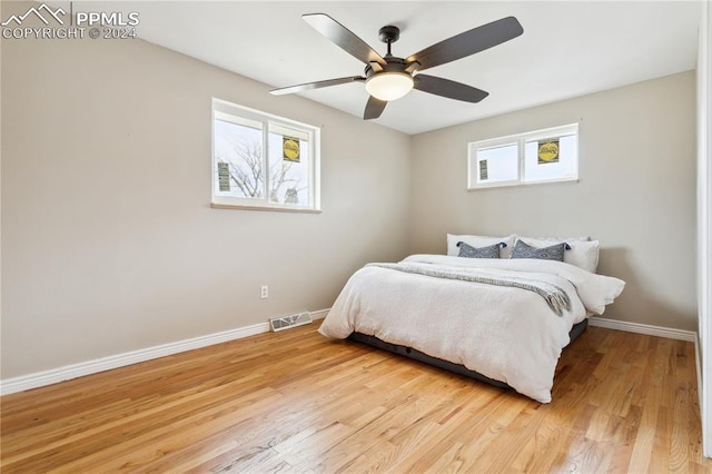 bedroom featuring light hardwood / wood-style flooring and ceiling fan