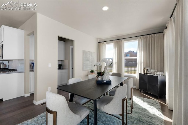 dining space with dark hardwood / wood-style floors