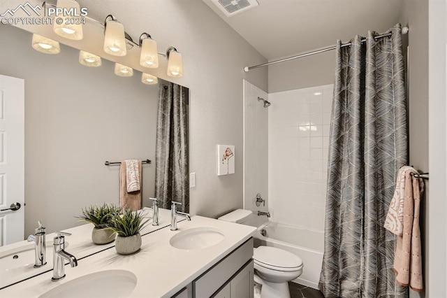 full bathroom featuring vanity, toilet, and shower / tub combo