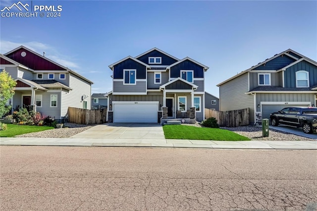 craftsman-style house featuring a front lawn and a garage