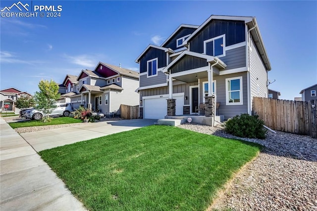 craftsman-style house featuring a front yard and a garage