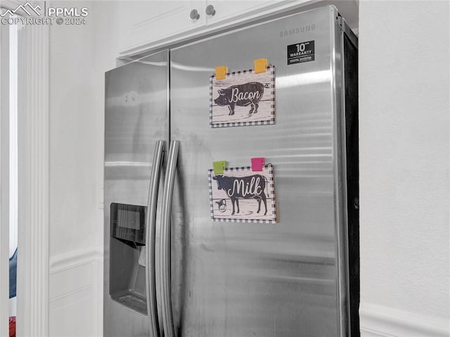 details featuring stainless steel fridge with ice dispenser