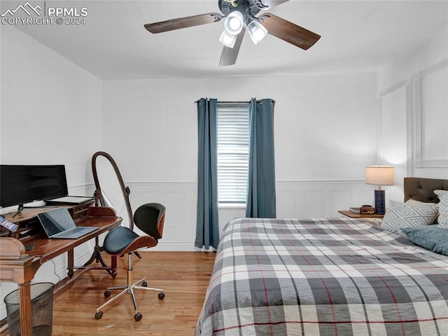 bedroom with ceiling fan and light hardwood / wood-style floors