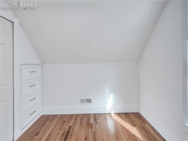 bonus room with lofted ceiling and wood-type flooring