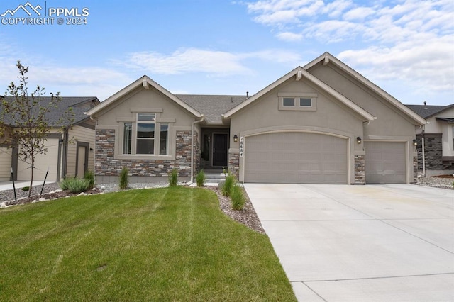 view of front of home with a garage and a front lawn