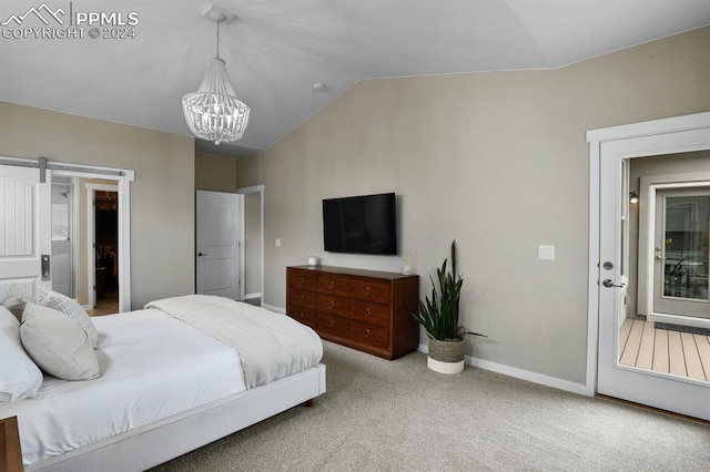 bedroom with lofted ceiling, light carpet, a barn door, and an inviting chandelier