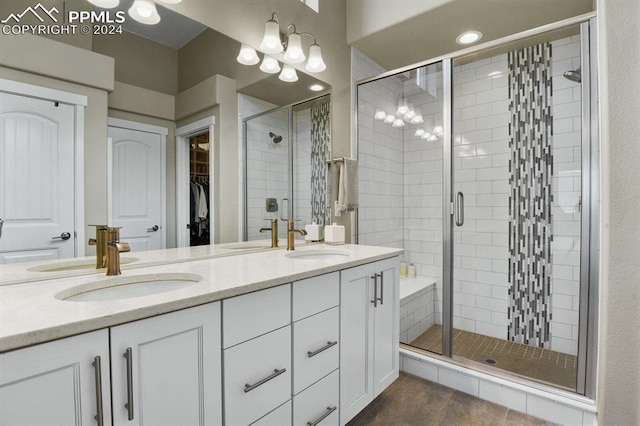 bathroom with walk in shower, tile patterned floors, and vanity