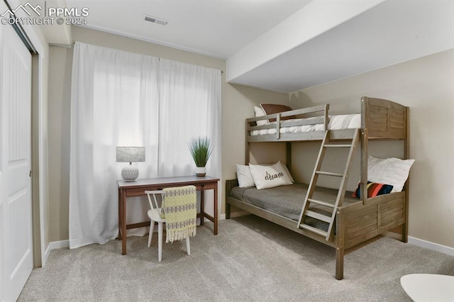 bedroom featuring light colored carpet