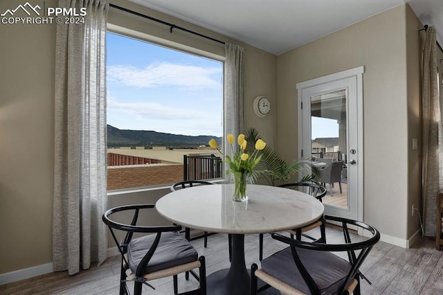 dining room featuring a mountain view and hardwood / wood-style floors