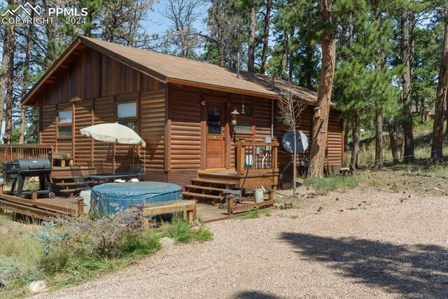 view of front of home with a swimming pool side deck