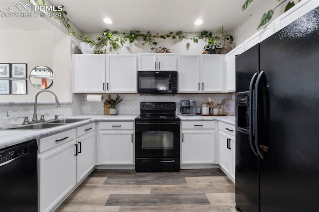 7375 Sandy Springs Pt, Fountain, CO 80817 - kitchen featuring light wood-type flooring, black appliances, a sink, white cabinets, and light countertops