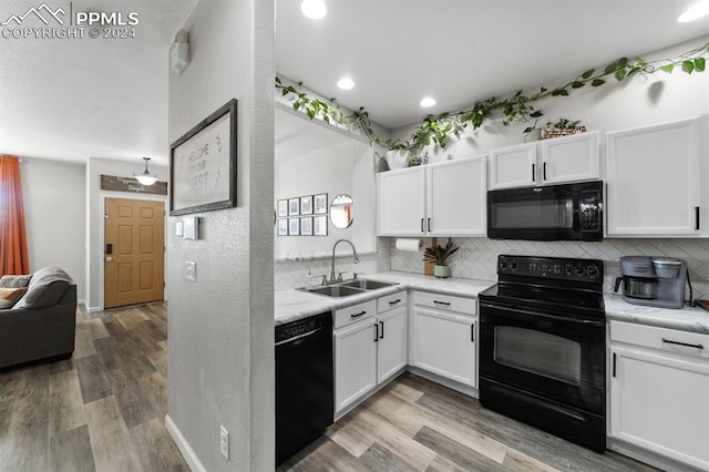 7375 Sandy Springs Pt, Fountain, CO 80817 - kitchen with backsplash, black appliances, light countertops, white cabinetry, and a sink