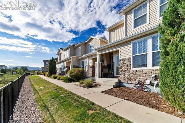 7375 Sandy Springs Pt, Fountain, CO 80817 - exterior space with a porch, fence, and stone siding