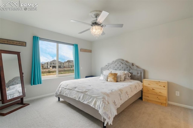 bedroom featuring ceiling fan and light carpet