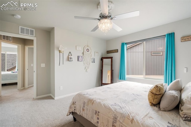 bedroom featuring light colored carpet and ceiling fan