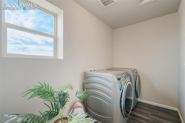 laundry room featuring dark hardwood / wood-style flooring and washing machine and clothes dryer