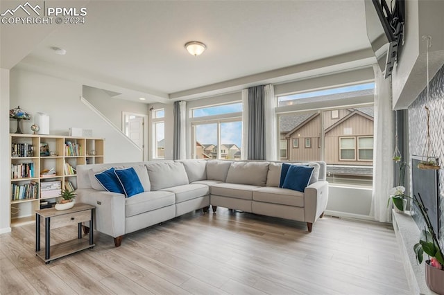 living room with hardwood / wood-style floors and a wall mounted air conditioner