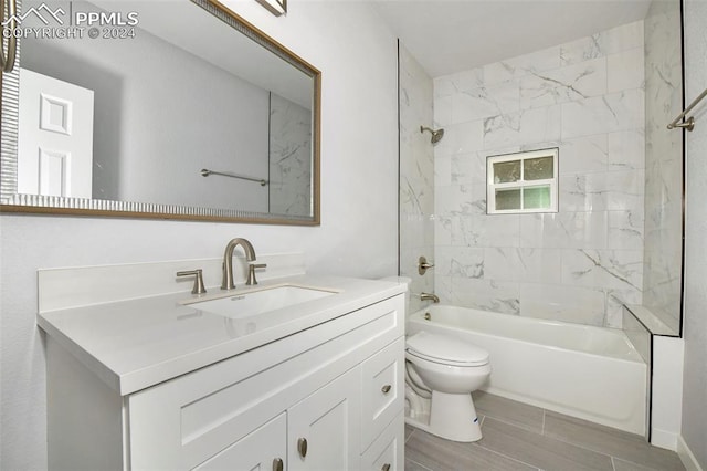 full bathroom featuring vanity, toilet, and tiled shower / bath combo