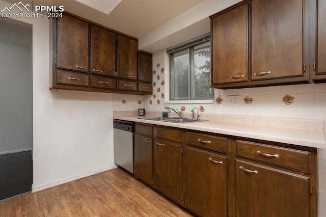 kitchen with light hardwood / wood-style flooring, backsplash, sink, stainless steel dishwasher, and dark brown cabinetry