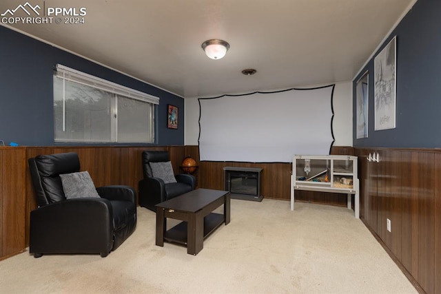 sitting room with carpet flooring and wood walls