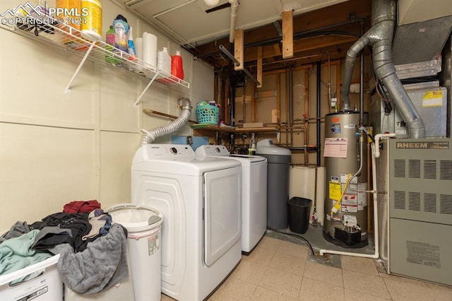 washroom with heating unit, washer and clothes dryer, and water heater