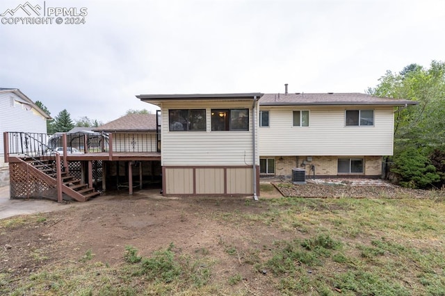 rear view of house with central AC and a wooden deck