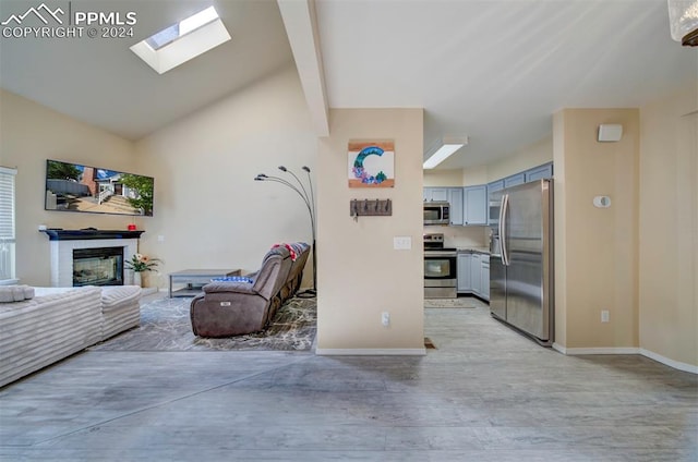 interior space with light hardwood / wood-style flooring and lofted ceiling with skylight