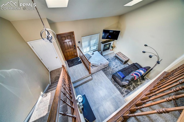 living room featuring high vaulted ceiling and carpet floors