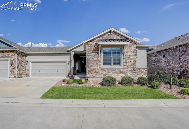 view of front of home with a front yard and a garage