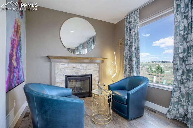 sitting room featuring hardwood / wood-style flooring and a fireplace