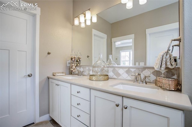 bathroom with vanity and tasteful backsplash