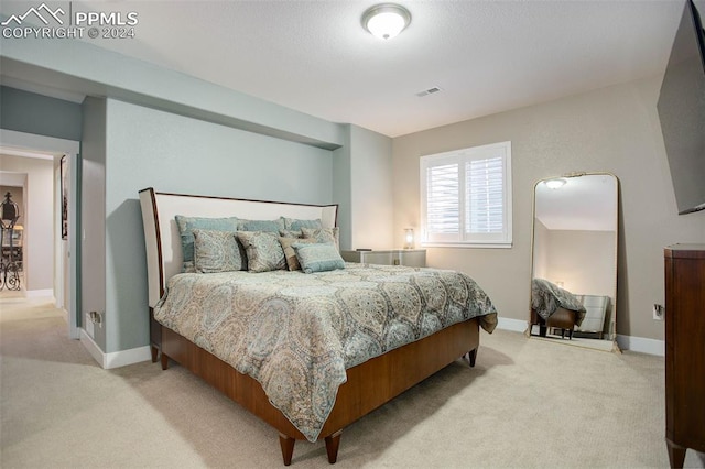 bedroom featuring light carpet