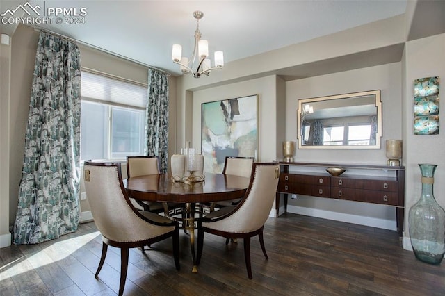 dining space featuring dark hardwood / wood-style flooring and an inviting chandelier