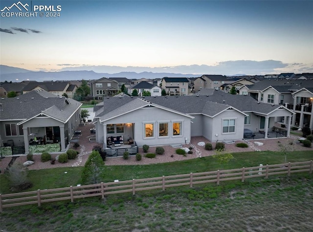 exterior space with a lawn, a patio area, and a mountain view