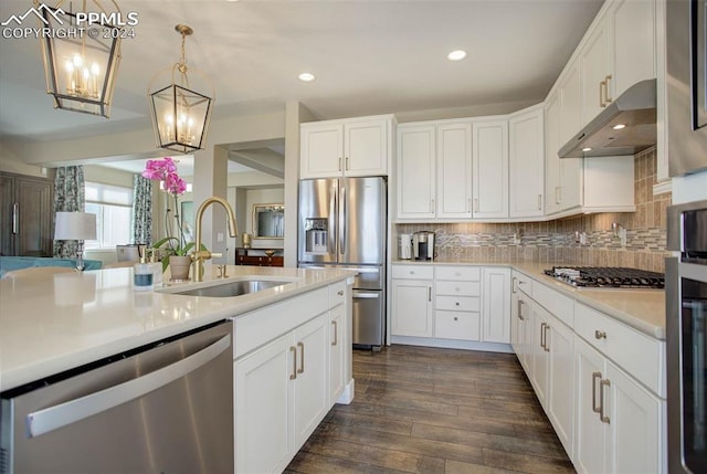 kitchen with dark wood-type flooring, stainless steel appliances, and white cabinetry