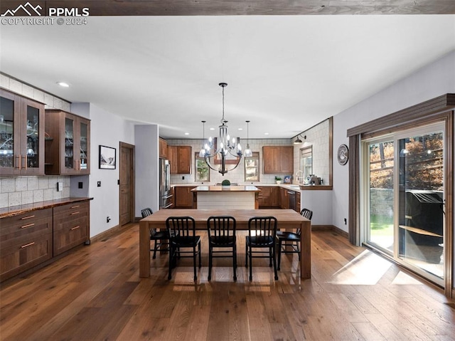 dining area with an inviting chandelier and dark hardwood / wood-style flooring