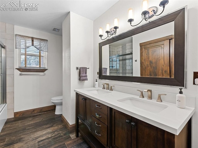 bathroom with vanity, toilet, wood-type flooring, and walk in shower