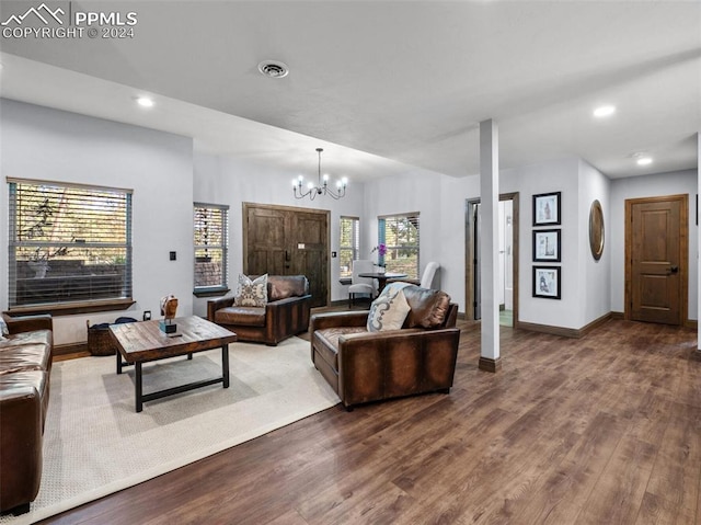 living room with an inviting chandelier and wood-type flooring