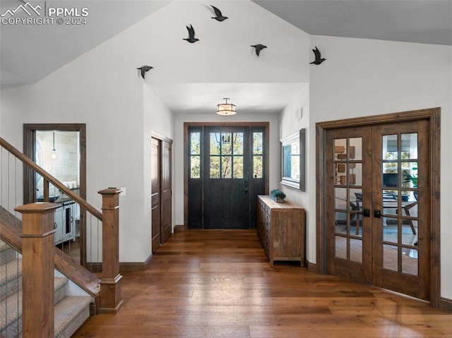 entryway with lofted ceiling, dark hardwood / wood-style floors, and french doors