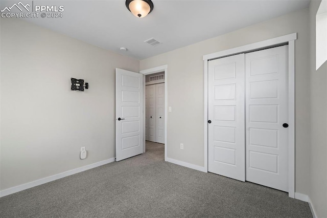 unfurnished bedroom featuring a closet and carpet floors