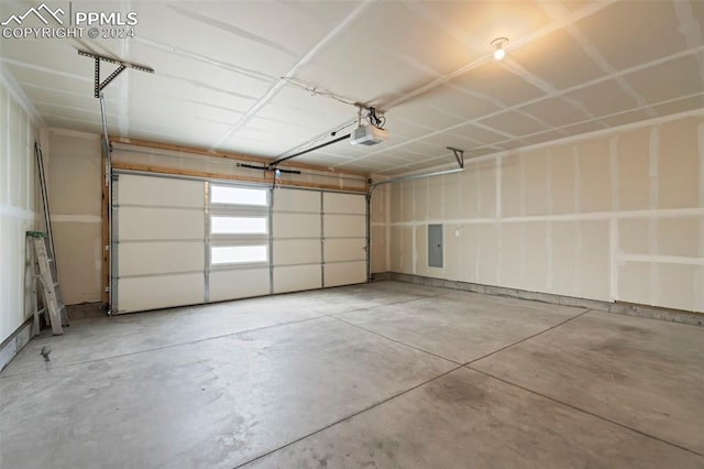 garage featuring a garage door opener and electric panel