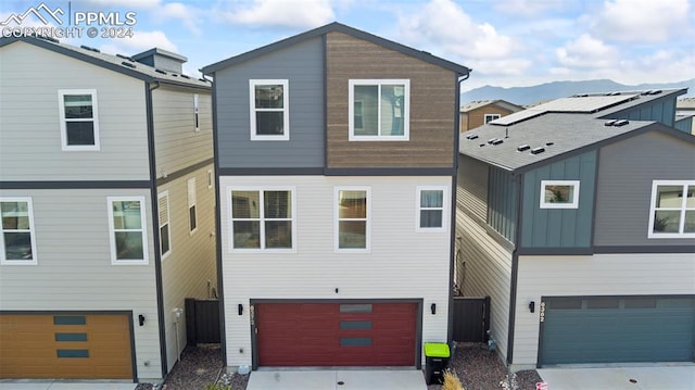 view of front of home with a mountain view and a garage