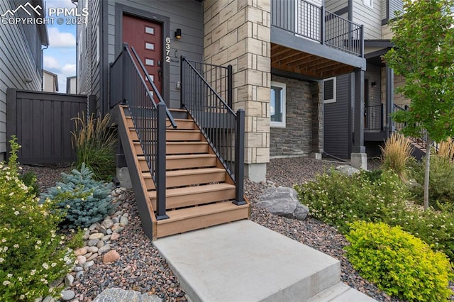 view of exterior entry featuring a balcony