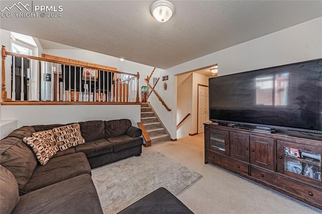 living room featuring light colored carpet and a textured ceiling