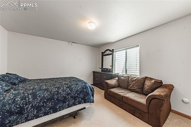 carpeted bedroom featuring a textured ceiling