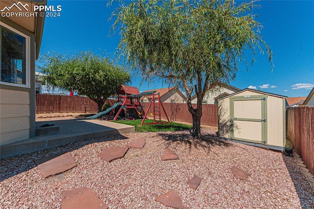 view of yard featuring a storage shed and a playground