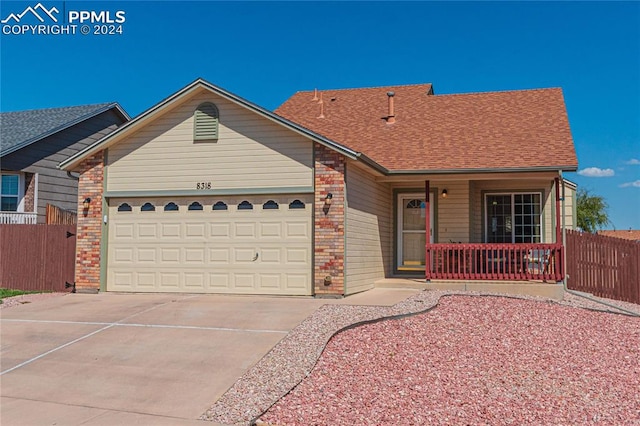 single story home with a porch and a garage