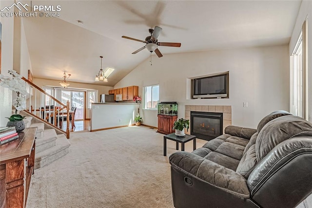 carpeted living room featuring lofted ceiling, a fireplace, and ceiling fan