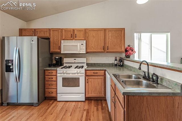 kitchen with white appliances, lofted ceiling, sink, and light hardwood / wood-style flooring